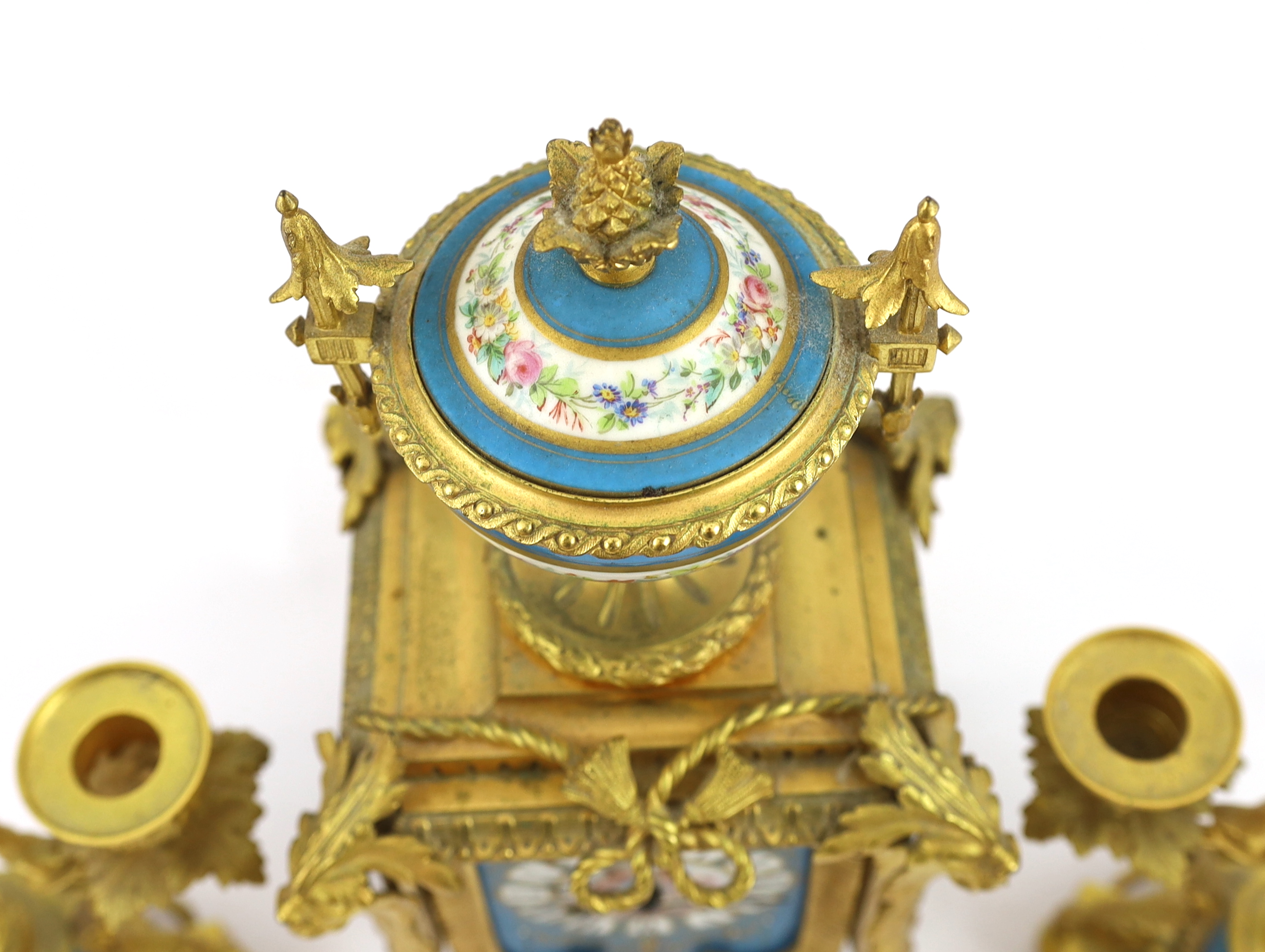 A 19th century French ormolu and Sevres style porcelain clock garniture, clock 19cm wide, 15cm deep, 37cm high candelabra 19cm wide, 30.5cm high